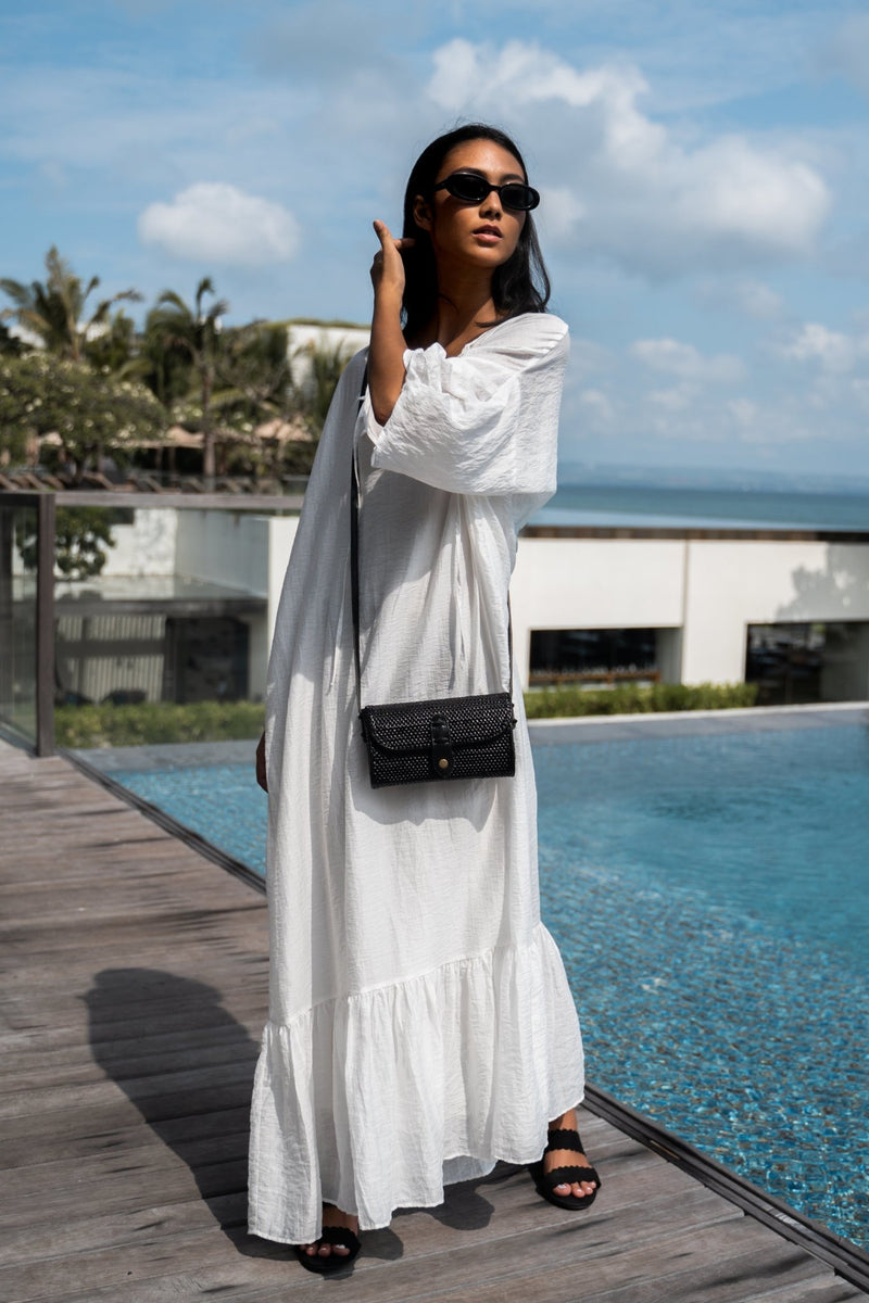 Model wearing white maxi dress, black sunglasses, and Jenn Lee Flores Crossbody